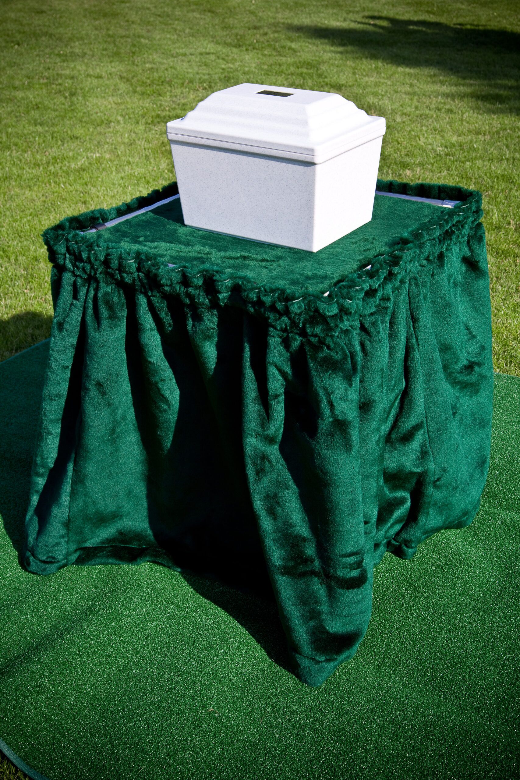 Stainless steel cremation stand with a drape and our fortress urn vault