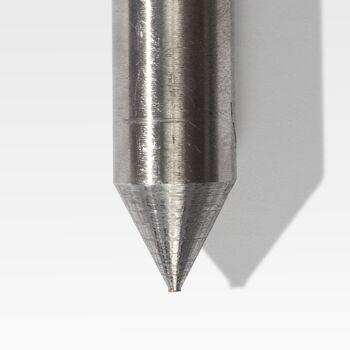 A close-up of the Tent & Wall Stakes, featuring a metallic pointed tip with a cylindrical shaft, casting a shadow on a light surface.