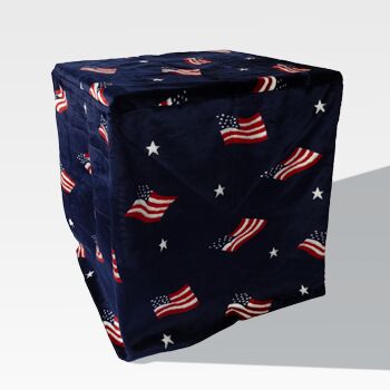 A cube-shaped object covered with dark fabric featuring American flags and white stars, similar to the EZ Fold Cremation Stand.