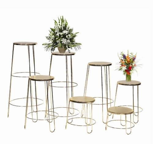 A set of five Round Basket Stands crafted from gold metal, designed with varying heights to hold exquisite flower arrangements. The taller stands showcase larger green and white flowers, while the shorter ones are adorned with vibrant, colorful bouquets.